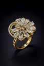 gold spiral floral statement ring with crystal detailing. Premium Vellorene fashion jewellery for boutique and global buyers.